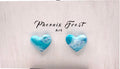 Two heart-shaped stud earrings with a blue and white marbled pattern, displayed on a light textured background with the text 'Phoenix Frost Art' above them.